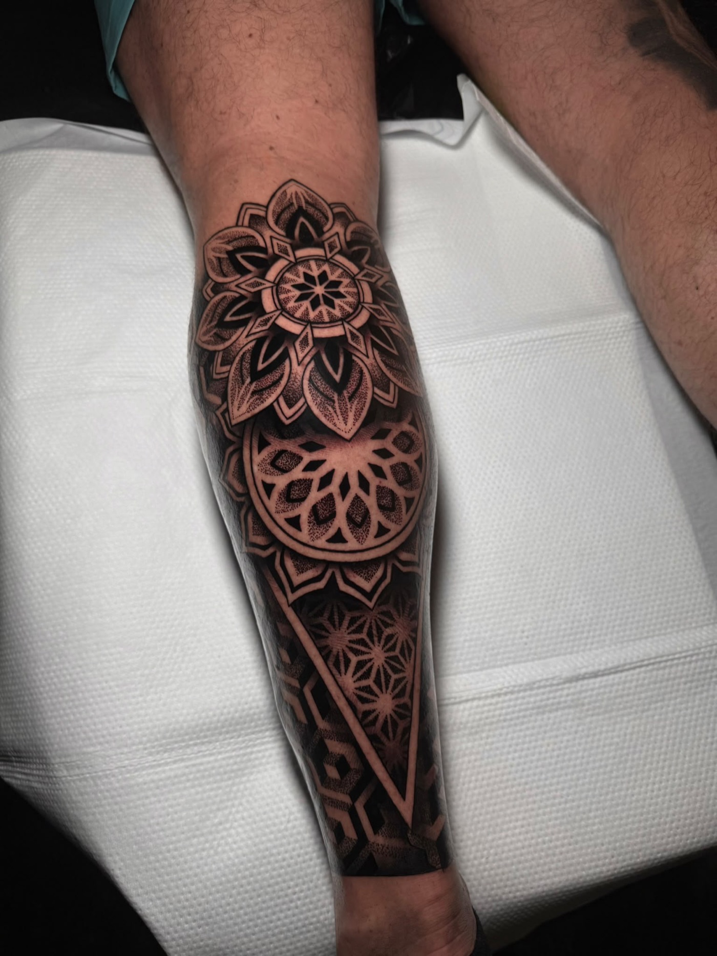 Geometric mandala forearm tattoo