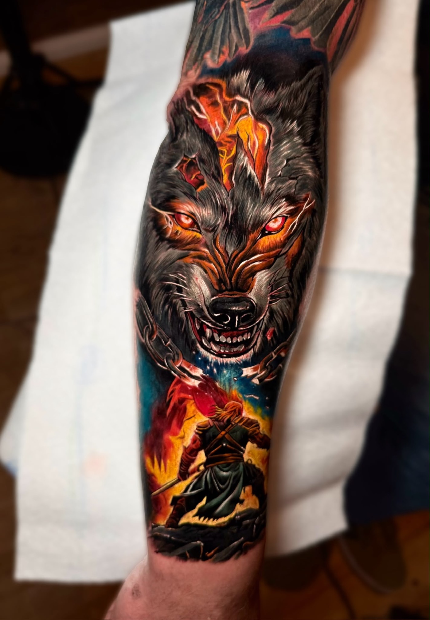 Vivid colour wolf and warrior forearm tattoo