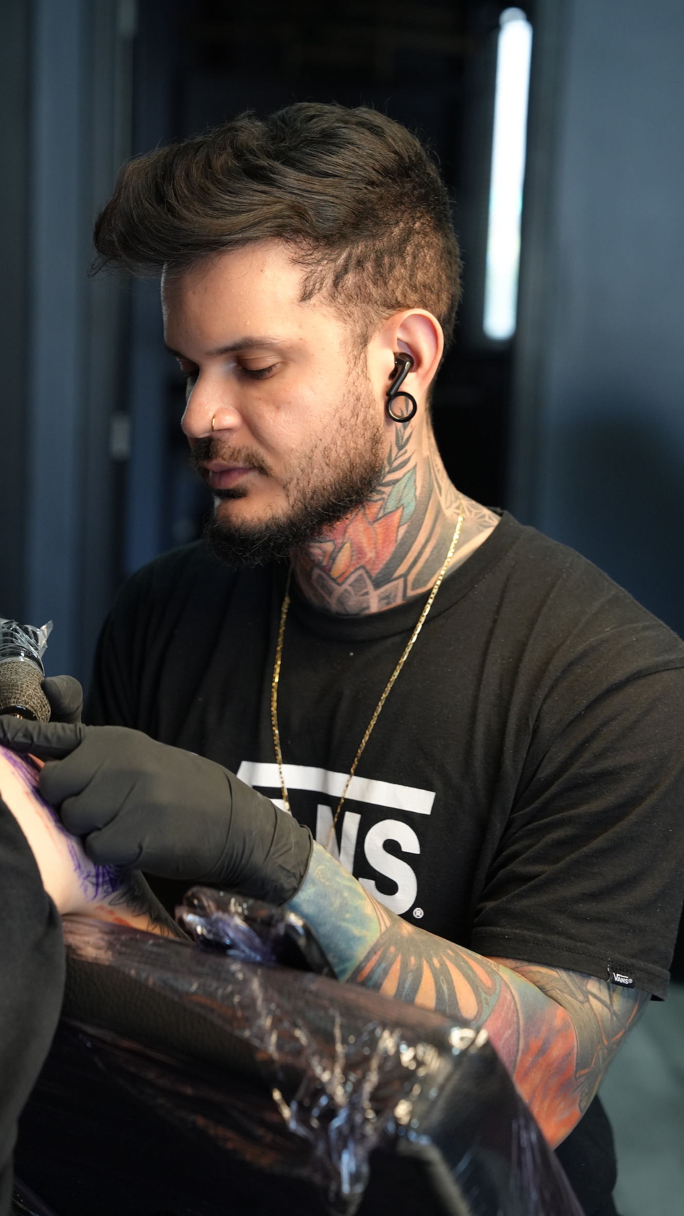 Esequiel Torres tattooing in his studio